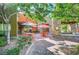Outdoor restaurant patio with colorful umbrellas, tables, and chairs, surrounded by greenery at 3514 Punta Tersiva Ln, Henderson, NV 89044