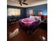 Cozy bedroom with wood floors, and decorative bedding and bright stained glass window at 3933 Lighthouse Ave, Las Vegas, NV 89110