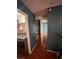 Hallway with wood flooring, closet space, and blue walls leading to other rooms in the home at 3933 Lighthouse Ave, Las Vegas, NV 89110