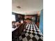 The kitchen features dark tile backsplashes, checkered floors, and stainless steel appliances at 3933 Lighthouse Ave, Las Vegas, NV 89110
