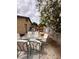 Patio seating area with a table, chairs, and lush greenery at 3933 Lighthouse Ave, Las Vegas, NV 89110