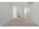 Hallway with carpet flooring, and white paint leading to multiple rooms, and a staircase at 4219 Gold Desert St, North Las Vegas, NV 89032