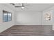 Spacious living room filled with natural light highlighting gray flooring, and a modern ceiling fan fixture at 4219 Gold Desert St, North Las Vegas, NV 89032