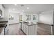 Well-lit open living area connected to a kitchen with stainless steel appliances, neutral countertops, and cabinetry at 4219 Gold Desert St, North Las Vegas, NV 89032