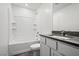 Bathroom featuring a tiled shower over tub, a large mirror, and a vanity with storage space at 4223 Gold Desert St, North Las Vegas, NV 89032