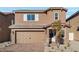 Charming two-story home featuring a brick driveway, two-car garage, and well-maintained landscaping at 4223 Gold Desert St, North Las Vegas, NV 89032