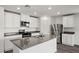 Well-lit kitchen boasting stainless steel appliances, and an island with a sink and breakfast bar at 4223 Gold Desert St, North Las Vegas, NV 89032