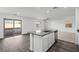 Kitchen features a center island with sink, stainless steel appliances and sliding glass door to backyard at 4223 Gold Desert St, North Las Vegas, NV 89032