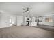 Spacious living area featuring a ceiling fan and open floor plan into the kitchen and dining area at 4223 Gold Desert St, North Las Vegas, NV 89032