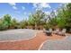 Spacious backyard featuring a charming fire pit with Adirondack chairs and serene landscaping at 4317 Via Vinci Ct, Pahrump, NV 89061