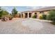 Desert-friendly backyard with gravel, stone, and a covered patio at 4317 Via Vinci Ct, Pahrump, NV 89061