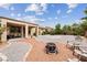 Desert-friendly backyard with gravel, stone, fire pit, and a covered patio at 4317 Via Vinci Ct, Pahrump, NV 89061
