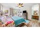 Bright bedroom with ceiling fan, wood floors, and ensuite bathroom at 4317 Via Vinci Ct, Pahrump, NV 89061