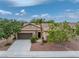 Expansive view of the well-maintained, single-story home featuring desert landscaping and an attached garage at 4317 Via Vinci Ct, Pahrump, NV 89061