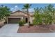 Inviting single-story home showcasing desert landscaping, a two-car garage, and a welcoming front entrance at 4317 Via Vinci Ct, Pahrump, NV 89061