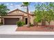 Charming single-story home with a two-car garage, desert landscaping and inviting front entrance at 4317 Via Vinci Ct, Pahrump, NV 89061