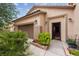 Attractive view of the home's entrance, highlighting the desert landscaping, and attached two car garage at 4317 Via Vinci Ct, Pahrump, NV 89061