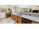 Kitchen with granite countertops, stainless sink, and seamless flow to living area with natural lighting at 4317 Via Vinci Ct, Pahrump, NV 89061
