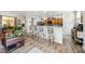 Open-concept kitchen and living area with barstool seating and modern finishes at 4317 Via Vinci Ct, Pahrump, NV 89061