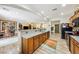 Spacious kitchen with granite countertops, wood cabinetry, and seamless transition to living/dining areas at 4317 Via Vinci Ct, Pahrump, NV 89061