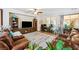 Comfortable living room with plush leather seating, entertainment center, and ample natural light at 4317 Via Vinci Ct, Pahrump, NV 89061