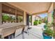 Covered patio and desert-friendly landscaping with table and chairs at 4317 Via Vinci Ct, Pahrump, NV 89061