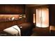 Relaxing spa room featuring a massage table, accent lighting, and upscale decor at 4381 W Flamingo Rd # 27309, Las Vegas, NV 89103