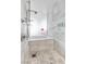 Modern bathroom featuring marble walls and a luxurious bathtub with a shower head at 4381 W Flamingo Rd # 5318, Las Vegas, NV 89103