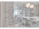 A luxurious bathroom featuring marble tiling, a glass shower, and modern fixtures at 4381 W Flamingo Rd # 5318, Las Vegas, NV 89103