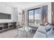 Modern living room with a light gray sofa and city view at 4381 W Flamingo Rd # 5318, Las Vegas, NV 89103