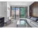 Bright living room featuring a modern sofa, stylish accent chair, and a sleek glass coffee table at 4381 W Flamingo Rd # 5318, Las Vegas, NV 89103