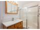 Bathroom featuring a walk-in shower and wooden vanity with a bright white countertop at 4412 Red Blanket Rd, North Las Vegas, NV 89032