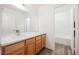 Bathroom featuring light countertops, a light wood vanity, and a separate shower and bath at 4412 Red Blanket Rd, North Las Vegas, NV 89032