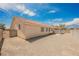 Exterior view of home with a tile roof and large private gravel backyard at 4412 Red Blanket Rd, North Las Vegas, NV 89032