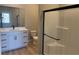 Bathroom featuring modern vanity, glass enclosed shower, and vinyl flooring at 4416 Cave Lake Ave, North Las Vegas, NV 89032