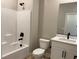 Bright bathroom features a shower-tub, modern vanity and black matte hardware at 4416 Cave Lake Ave, North Las Vegas, NV 89032