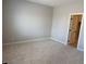 Spacious bedroom with neutral carpet, paint and a view of the entrance to the walk in closet at 4416 Cave Lake Ave, North Las Vegas, NV 89032