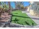 Well-designed backyard features a luscious lawn and block wall that offers a sense of privacy at 4416 Inez Dr, Las Vegas, NV 89130