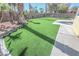 A well-maintained artificial lawn, patio, and block wall create a private outdoor retreat at 4416 Inez Dr, Las Vegas, NV 89130
