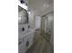 Beautiful bathroom featuring a double vanity with marble countertops, black fixtures, and sliding mirror closet at 4416 Inez Dr, Las Vegas, NV 89130