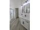 Modern bathroom with double vanity, white marble countertop, black fixtures, and walk-in shower at 4416 Inez Dr, Las Vegas, NV 89130