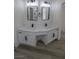 Stylish bathroom featuring a double vanity with marble countertops, black hardware, and modern mirrors at 4416 Inez Dr, Las Vegas, NV 89130