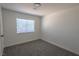 Clean, light-filled bedroom with neutral carpeting and a large window at 4416 Inez Dr, Las Vegas, NV 89130