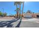 Charming single-story home features a two-car garage, desert landscaping, and swaying palm trees at 4416 Inez Dr, Las Vegas, NV 89130