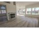 Bright living room with modern fireplace, laminate floors, and large windows overlooking a pool at 4416 Inez Dr, Las Vegas, NV 89130