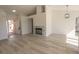 Spacious living room with fireplace, light flooring, and welcoming front door at 4416 Inez Dr, Las Vegas, NV 89130