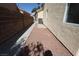 Exterior view of the side yard with gravel landscaping and view of the fence and gate at 4416 Inez Dr, Las Vegas, NV 89130