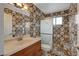 Updated bathroom with a vanity, mirror and unique decorative tiles in the shower at 4430 Eureka Cir, Las Vegas, NV 89103