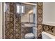 Updated bathroom with decorative tiles, a glass shower stall and a window for natural light at 4430 Eureka Cir, Las Vegas, NV 89103