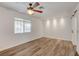 Bedroom with a ceiling fan, wood floors and a window for natural light and street views at 4430 Eureka Cir, Las Vegas, NV 89103
